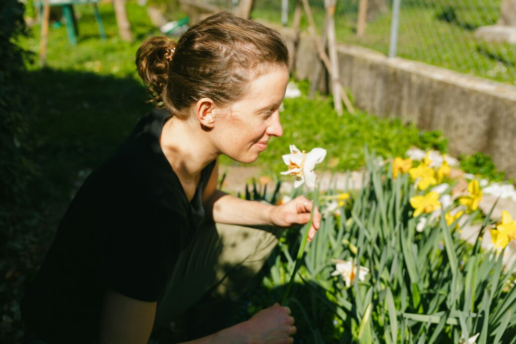 A women smelling flowers